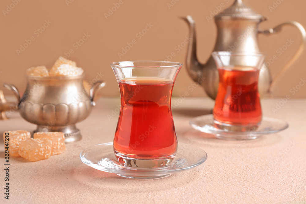 Tasty Turkish tea with sweets on color background Tasty Turkish tea with sweets on color background