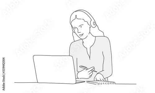 Woman in headphones looks at a laptop. Line drawing vector illustration.