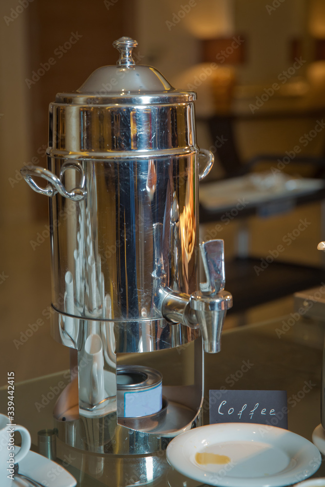 Hot beverages catering. Metal milk cap for coffee . Thermos with hot water  and cups for afternoon coffee on the wood table in luxury five star hotel.  Stock 写真 | Adobe Stock