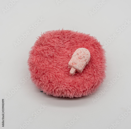 Cute Mini ice-cream bath bomb on red fluffy carpet