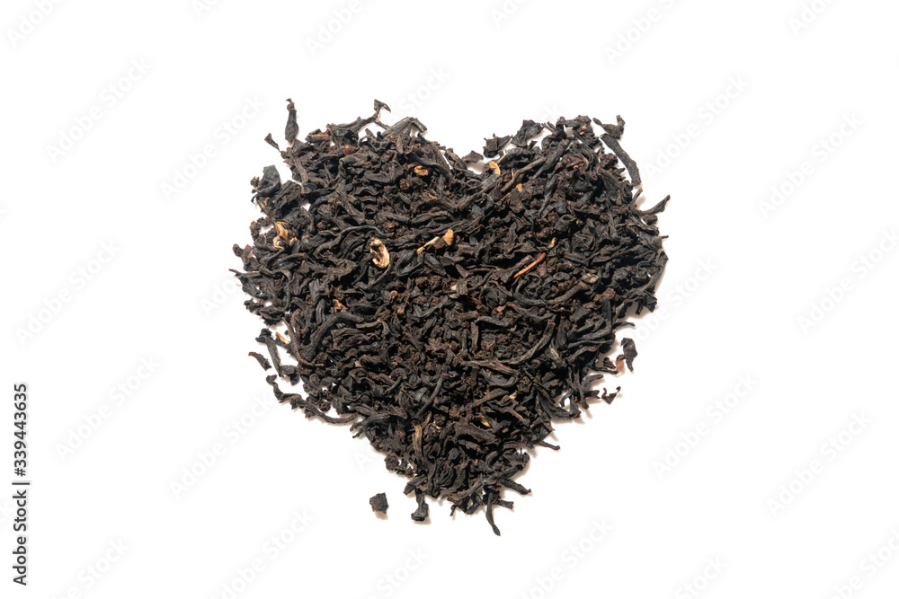 Heap of everyday brew loose dried organic black tea heart shape made with whole leaves isolated on white. Top view Heap of everyday brew loose dried organic black tea heart shape made with whole leaves isolated on white. Top view