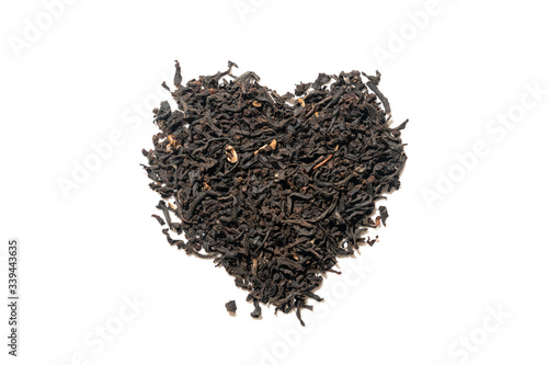 Heap of everyday brew loose dried organic black tea heart shape made with whole leaves isolated on white. Top view