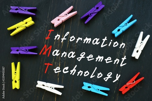 The caption in the picture is Information Management Technology IMT. Notebook sheet, table, pens. photo