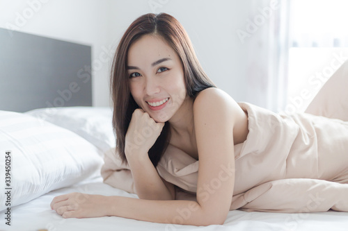 Beautiful woman lying on the bed. stay at home. work from home concept