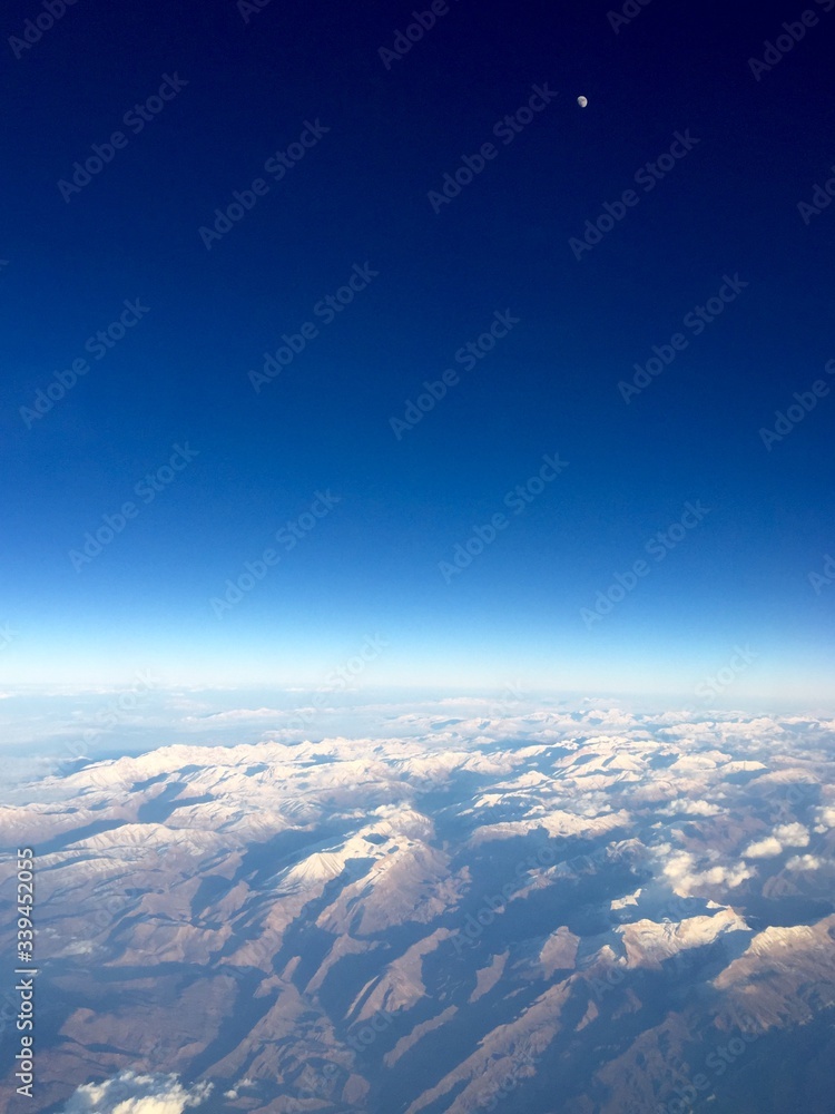 Aerial View Of Snowcapped Mountains Against Clear Blue Sky