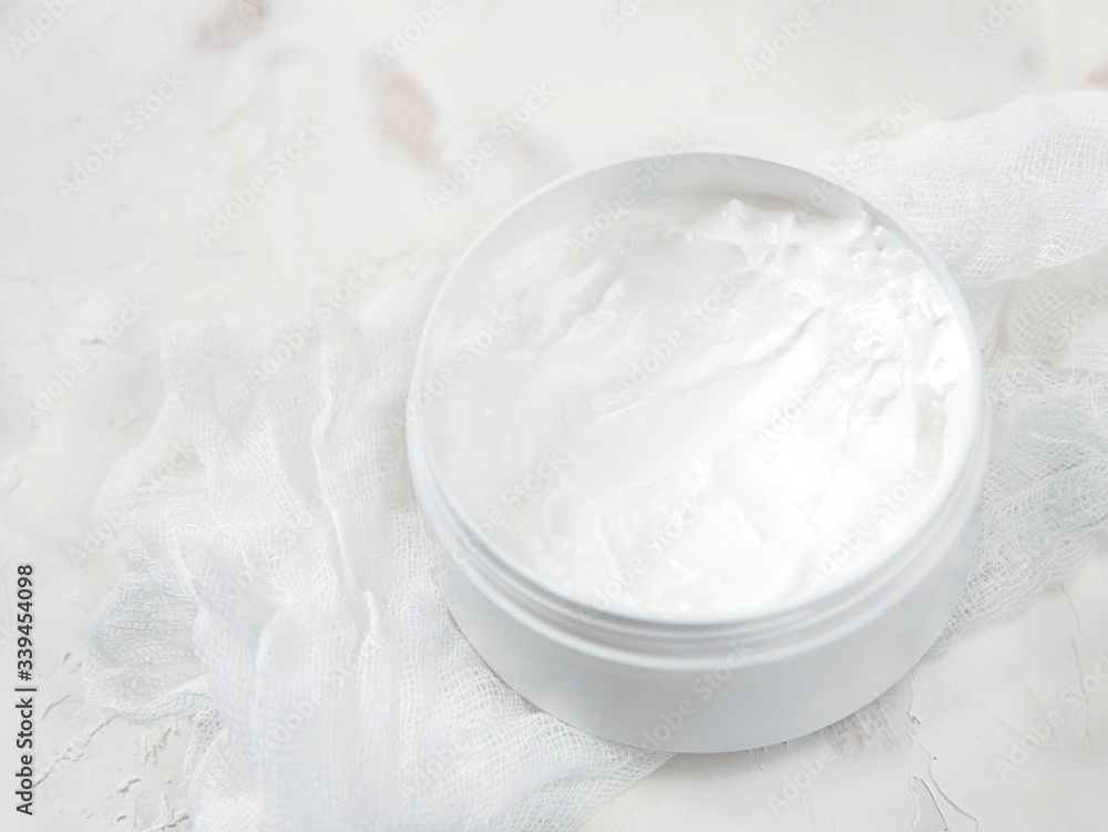 White medical cream in a jar on a white background White medical cream in a jar on a white background