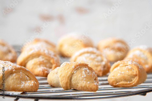 Homemade mini croissants on a cooling rack. Confectionery menu concept