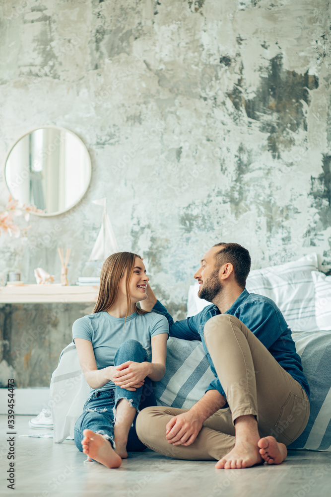 Cute couple smiling to each other in the bedroom stock photo