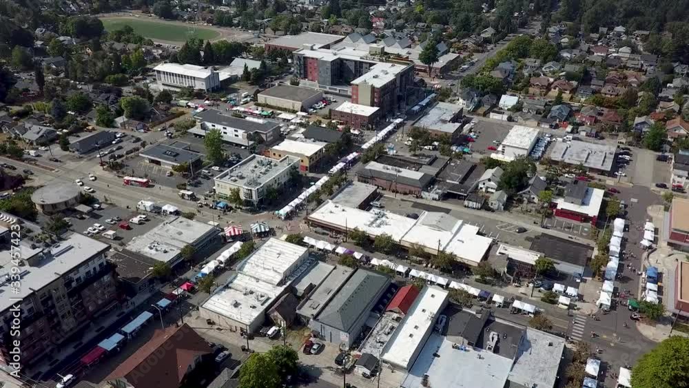 Street Festival In Tacoma, Washington Surrounded With High Buildings and Different Cars - Aerial Shot Street Festival In Tacoma, Washington Surrounded With High Buildings and Different Cars - Aerial Shot