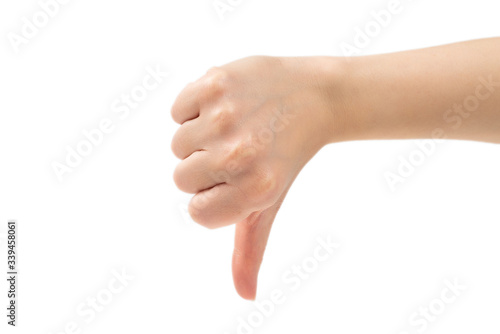 Thumb down female hand sign isolated on a white background.