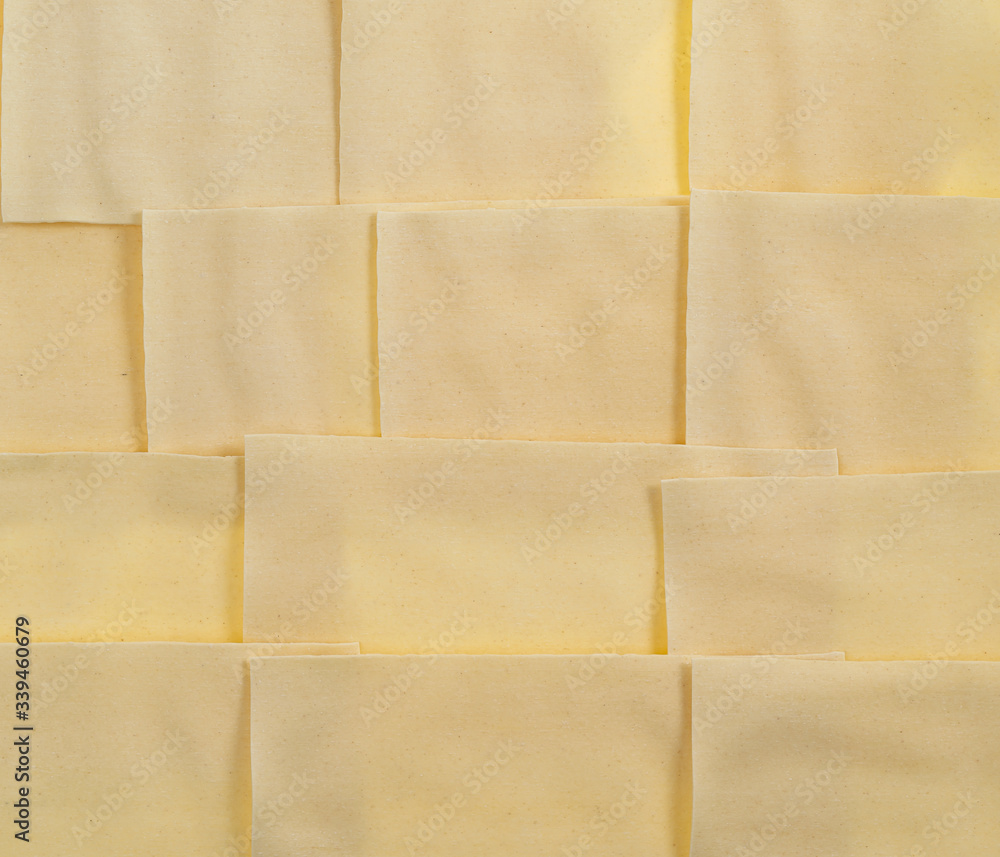 Fototapeta premium Sheets for lasagna isolated on white background. Pile of dry uncooked Italian pasta