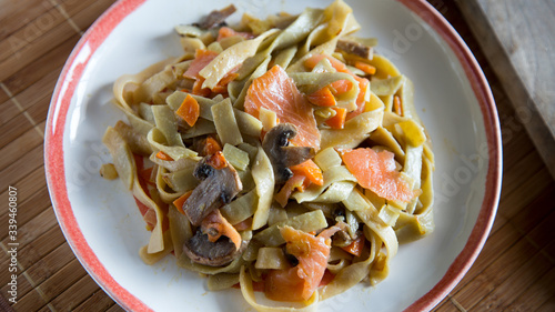 Tagliatele with mushrooms and salmon photo