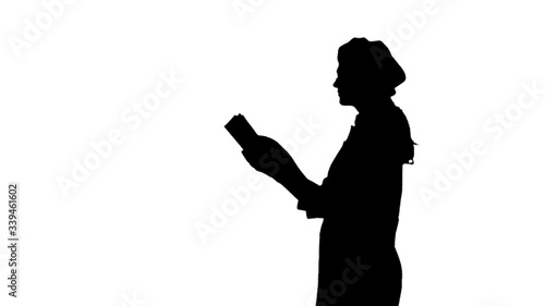 Black silhouette of chef lady with long hair reading cookbook.