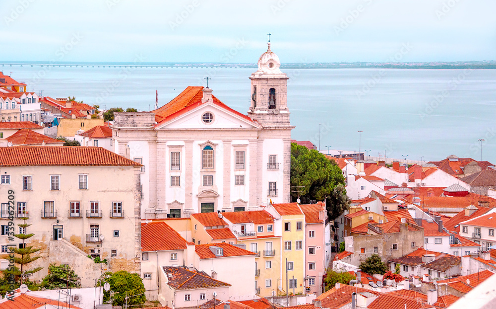 Lisbon. Portugal. Beautiful view of the city, a tourist route along the famous Alfama district. Miradouro de Santa Luzia viewpoint with the Alfama old town and Saint Stephen Church in background.