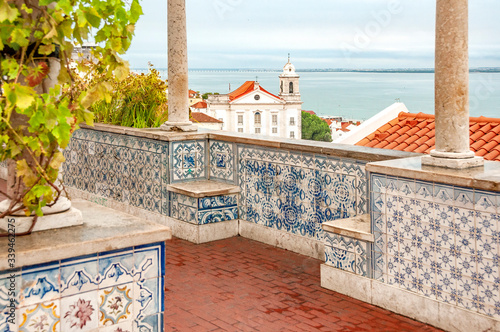 Lisbon. Portugal. Beautiful view of the city, a tourist route along the famous Alfama district. Miradouro de Santa Luzia viewpoint with the Alfama old town and Saint Stephen Church in background.