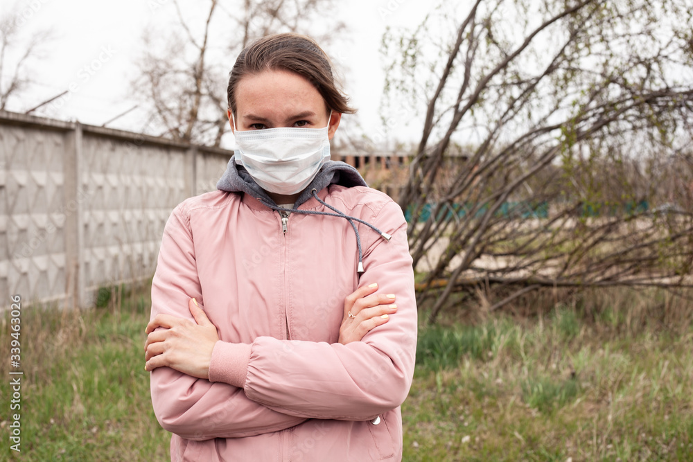 Girl in a medical white mask. Dressed in a pink jacket, in the background a concrete fence, grass and trees. Quarantine time.
Portrait photo, photo for inscription.
Girl in a medical white mask. Dressed in a pink jacket, in the background a concrete fence, grass and trees. Quarantine time.
Portrait photo, photo for inscription.