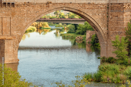 Beautiful landscape with a bridge. Traditional stone bridge in Toledo  Spain. View of Tagus River or R  o Tajo.