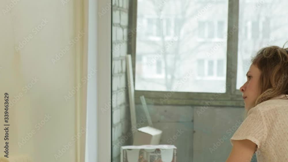 Female house painters paint the walls in the room. Female house painters paint the walls in the room.