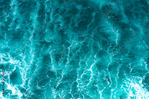 Fototapeta Naklejka Na Ścianę i Meble -  Texture Light blue surface of raging sea water with white foam and wave pattern
