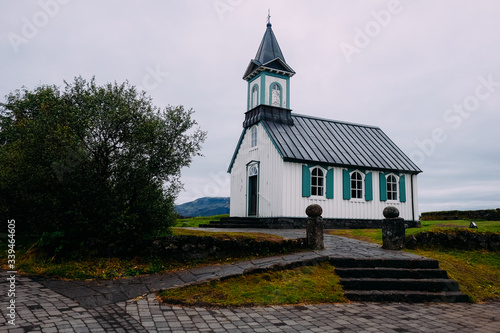 white wooden church in iceland national park in cloudy summer weather