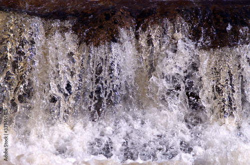 Fresh waterfall, white water with stones in close up scenic. The picture is taken in Bollebygd, Sweden.