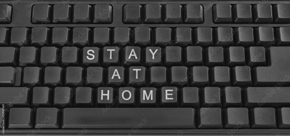 Text on PC keyboard - stay at home. Coronavirus. Quarantine. Coronavirus pandemic in the world. Text on PC keyboard - stay at home. Coronavirus. Quarantine. Coronavirus pandemic in the world.