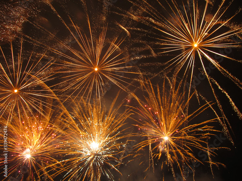 yellow explosions and trails of new year fireworks