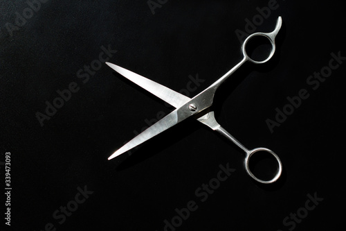 Stylish Professional Barber Scissors, Hair Cutting on black background. Hairdresser salon concept, Hairdressing Set. Haircut accessories. Copy space image, flat lay
