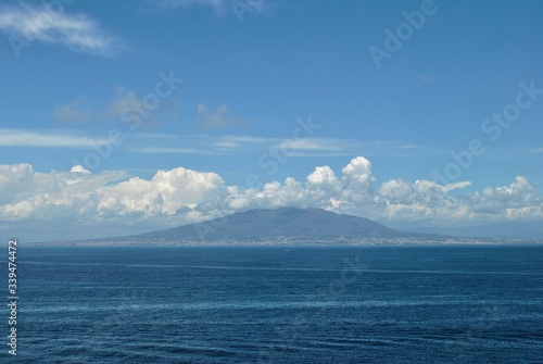 Volcano Vesuvius panorama Pompeii old Italian town ruins mystical history tragedy memory clouds blue sea sky background