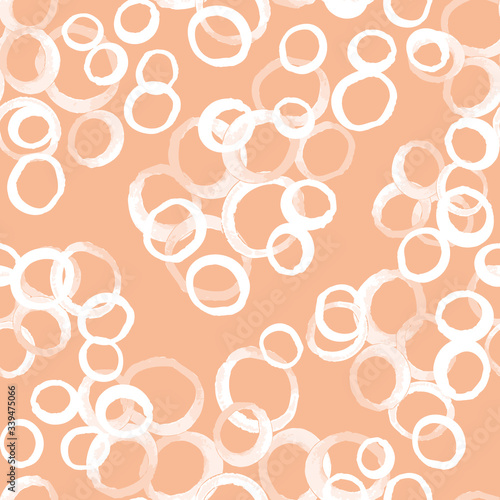 Vector seamless pattern with irregular overlapping circles texture. White doodle rings on peach background. Abstract vector background. Wallpaper, cloth design, fabric, paper, textile. Hand drawn.