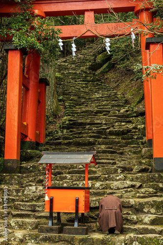 Kamikura Shrine and a pilgrim. Kumano Kodo is a Unesco World Heritage site ancient pilgrimage route in Japan photo