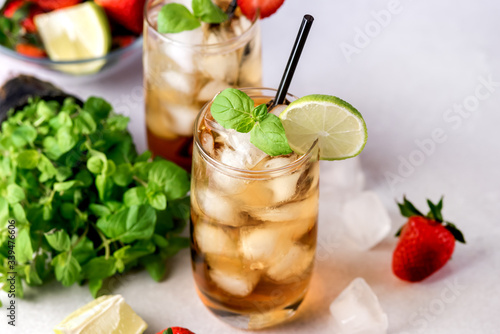 Gasses of Cold Citrus and Strawberry Ice Tea Decorated with Slice of Lemon and Strawberry Healthy Summer Drink Horizontal Fresh Mint