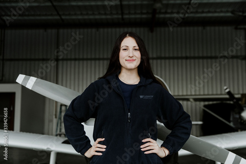 Young female pilot posing