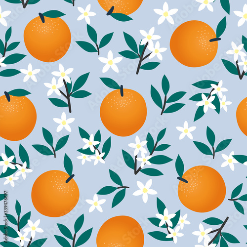 Seamless pattern of oranges, flowers and leaves on blue. Fruit vector background