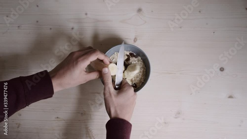 cutting a banana for a cereal bowl photo