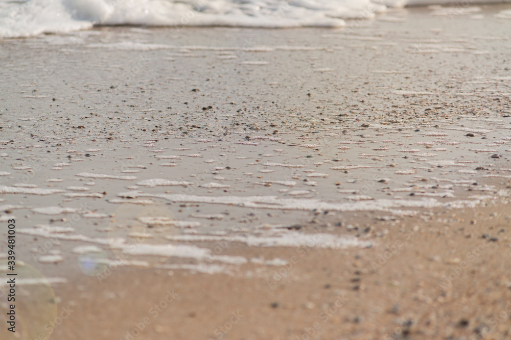 wave of blue ocean on sandy beach. texture Background. wave of blue ocean on sandy beach. texture Background.