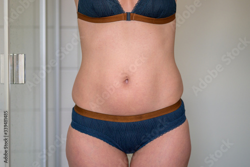 Midriff of a slim 38 year old woman in underwear