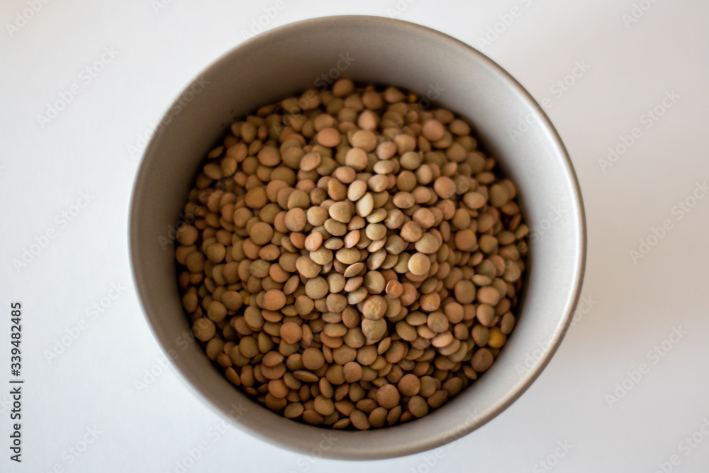 brown lentils in gray bowl brown lentils in gray bowl