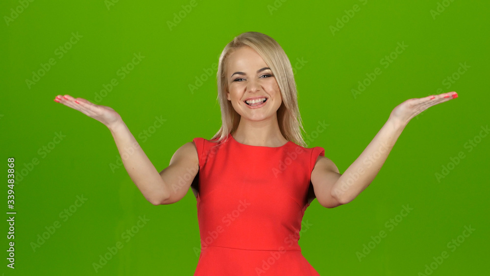 Lady in red on green screen background shows her hands palms up Lady in red on green screen background shows her hands palms up