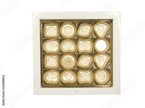 Empty box of gold color from chocolates isolated on a white background.