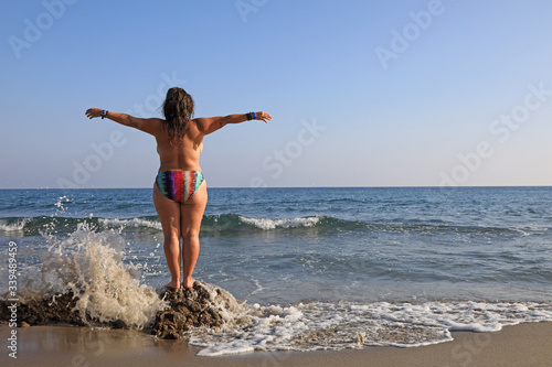 mujer joven haciendo yoga en la playa toples almería 4M0A6141-as20 photo