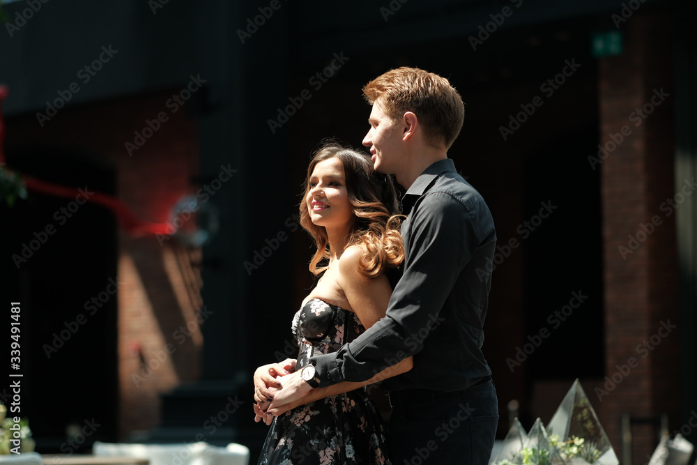 beautiful couple-a girl in a magnificent dress and a guy in a black shirt and trousers are in a building with a beautiful interior beautiful couple-a girl in a magnificent dress and a guy in a black shirt and trousers are in a building with a beautiful interior