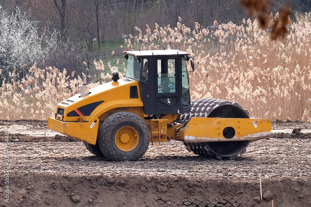 Fototapeta premium Soil skating rink working to sealing ground the base of road. Construction Heavy Industrial Machine Road roller Build a New Highway