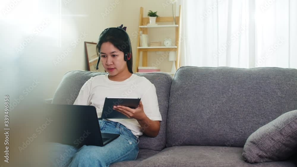 Asian freelance business woman casual wear using laptop working call video conference with customer in workplace in living room from home when social distancing stay at home and self quarantine time. Asian freelance business woman casual wear using laptop working call video conference with customer in workplace in living room from home when social distancing stay at home and self quarantine time.
