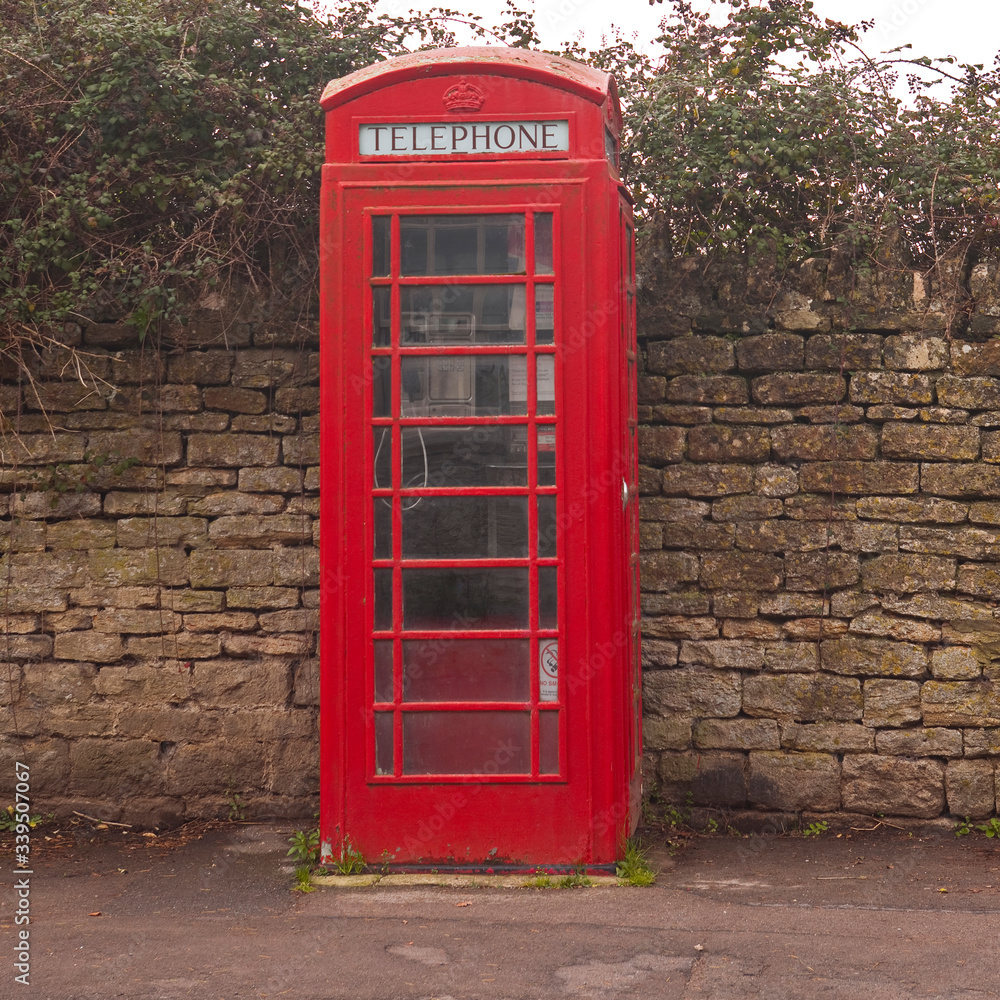 An old telephone box in Lacock, Wiltshire, UK. An old telephone box in Lacock, Wiltshire, UK.