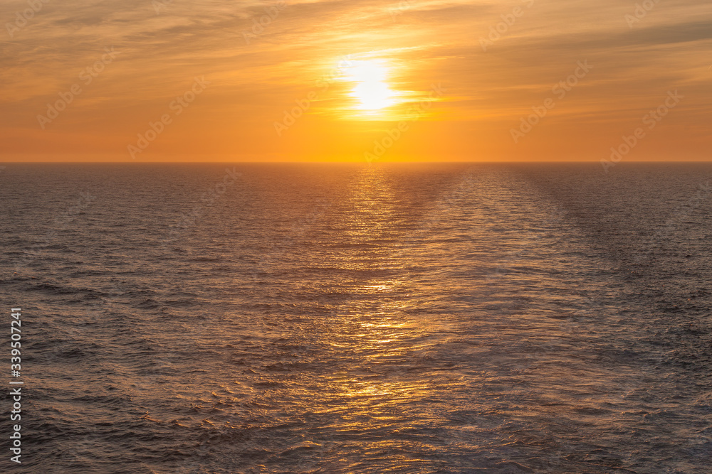Sunset on the sea where you can see the wake left by a cruise ship, Adriatic sea, Italy
