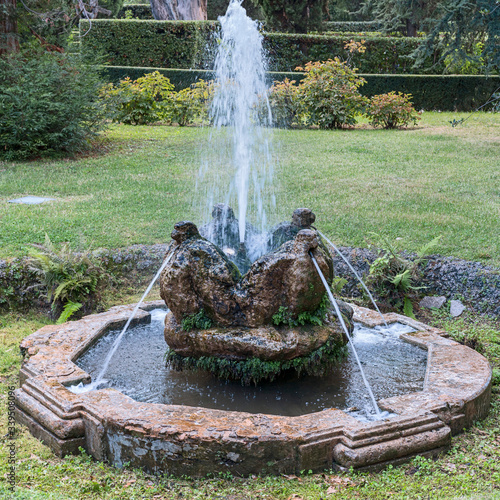 beautiful stone fountain with sculptures of monkeys in a suburban Roman park