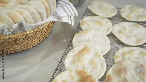 Indoor Slider Shot of Flat Circular Home Made Breads on Oven Rack and Basket photo