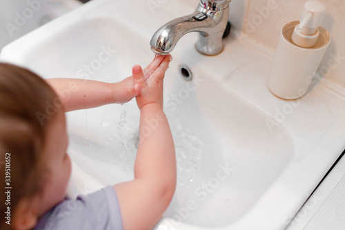 girl washes hands in the bathroom