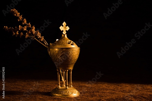 Принти на полотні Beautiful church censer with a dried branch with a dark background